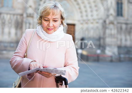 adult woman holding map guide adult woman holding map guide 42622342