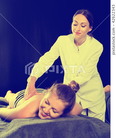 Relaxing professional massage for young woman Relaxing professional massage for young woman 42622343