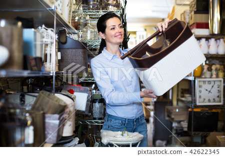 Female consumer holding leather box Female consumer holding leather box 42622345