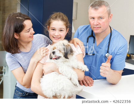 Happy family with dog consulting by veterinarian Happy family with dog consulting by veterinarian 42622356
