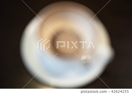 A cup of hot white coffee was consumed with coffee 42624255
