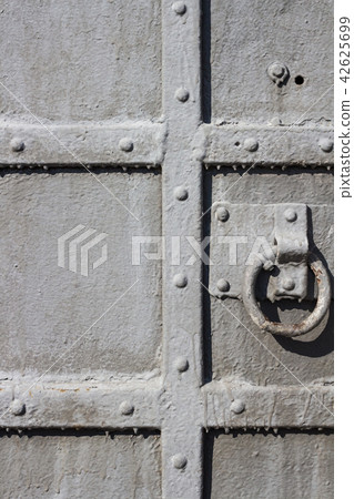 Old metal door close-up with round handle Old metal door close-up with round handle 42625699