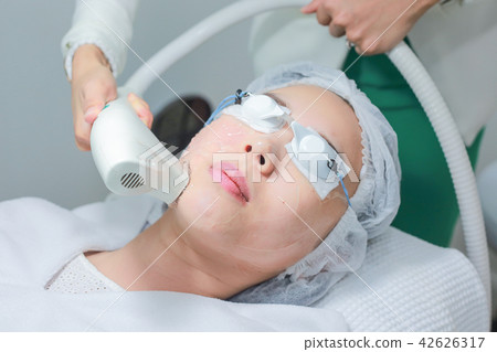 Beautician Giving Laser Treatment To Woman Face. 42626317