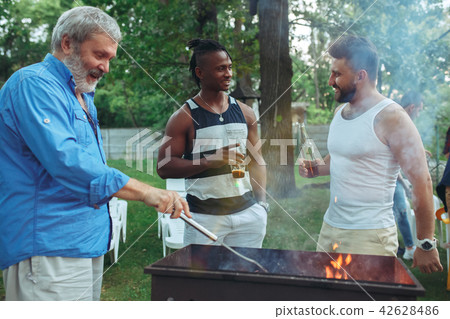 Group of friends making barbecue in the backyard. concept about good and positive mood with friends 42628486