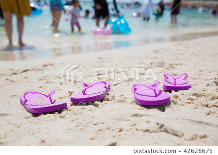 Sandy beach and beach sandals 42628675