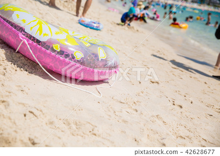 Sandy beach and floating wheel 42628677