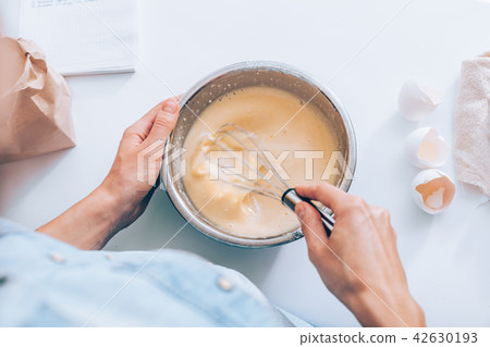 Candid image woman mixing batter Candid image woman mixing batter 42630193
