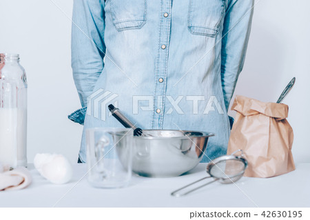 Woman wearing blue shirt standing at white Woman wearing blue shirt standing at white 42630195
