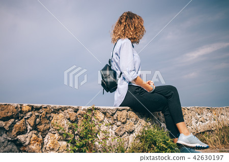 Female wearing blue shirt, black pants Female wearing blue shirt, black pants 42630197