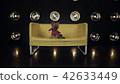 Cute obedient yorkshire terrier in Santa's suit is sitting on yellow couch and looking in camera 42633449