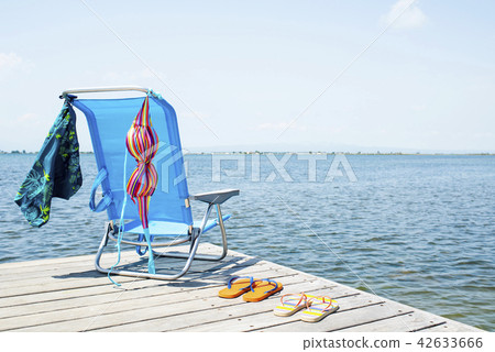 flip-flops, bikini and swimming trunks on a pier flip-flops, bikini and swimming trunks on a pier 42633666