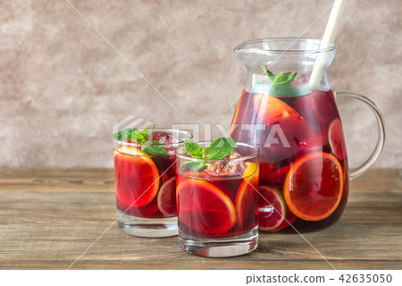 A pitcher and two glasses with Spanish Sangria A pitcher and two glasses with Spanish Sangria 42635050