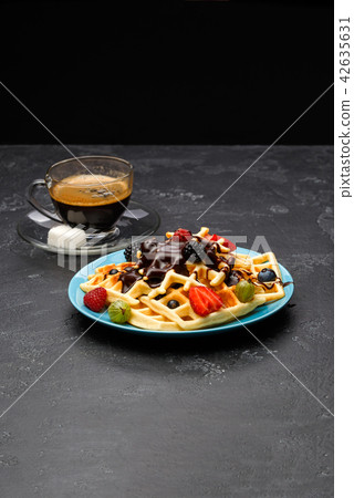 Photo of cup of coffee with Belgian wafers with strawberries, raspberries Photo of cup of coffee with Belgian wafers with strawberries, raspberries 42635631