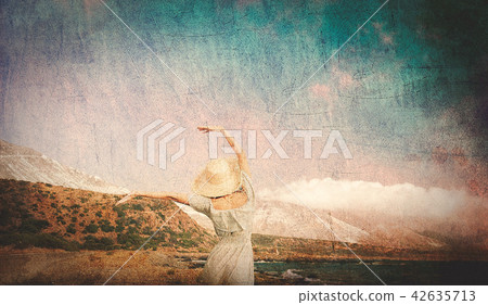 Caucasian girl in hat and white dress on sea coast Caucasian girl in hat and white dress on sea coast 42635713