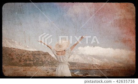 Caucasian girl in hat and white dress on sea coast Caucasian girl in hat and white dress on sea coast 42635716
