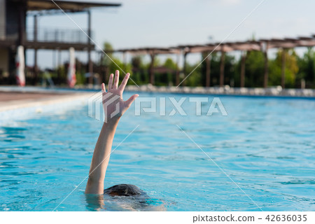 Hand up in swimming pool 42636035