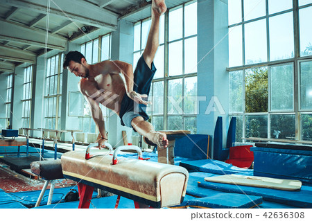 The sportsman during difficult exercise, sports gymnastics The sportsman during difficult exercise, sports gymnastics 42636308