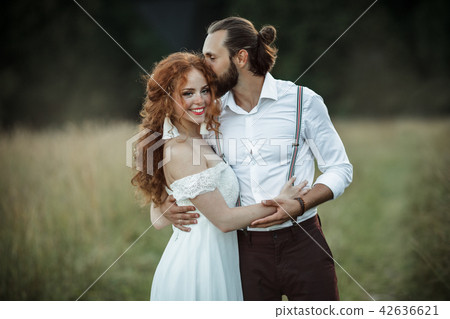 Happy lovely couple bride and groom are walking in the field, wedding and adventure concept 42636621