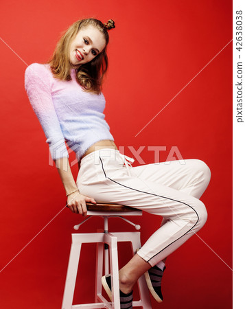 young pretty teenage girl on bright red background, happy smiling lifestyle people concept closeup young pretty teenage girl on bright red background, happy smiling lifestyle people concept closeup 42638038