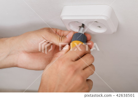 electrician installing electrical socket 42638501