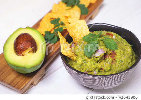 Japanese serve of avocado guacamole with chips 42643906