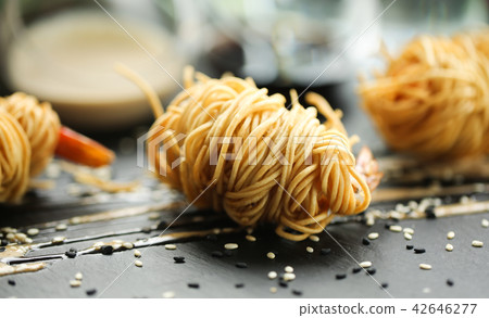 close up food photo of fried tiger prawns in egg noodles on black slate background. Asian culture close up food photo of fried tiger prawns in egg noodles on black slate background. Asian culture 42646277