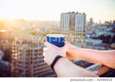 Close up man's hands holding take away paper cup with morning hot drink - coffee or tea with 42646918