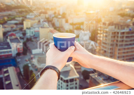 Close up man's hands holding take away paper cup with morning hot drink - coffee or tea with 42646923