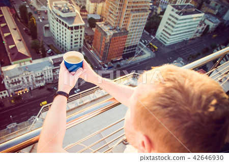 Close up man's hands holding take away paper cup with morning hot drink - coffee or tea with 42646930