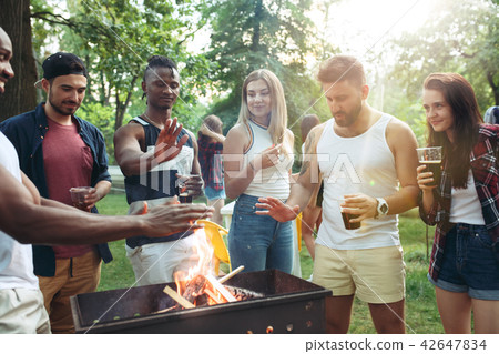 Group of friends making barbecue in the backyard. concept about good and positive mood with friends Group of friends making barbecue in the backyard. concept about good and positive mood with friends 42647834