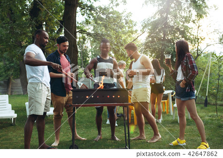 Group of friends making barbecue in the backyard. concept about good and positive mood with friends 42647862