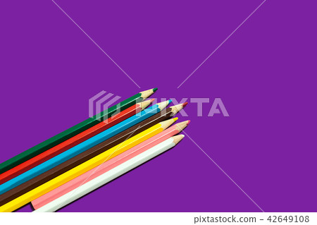 line of colored pencils on a purple background line of colored pencils on a purple background 42649108
