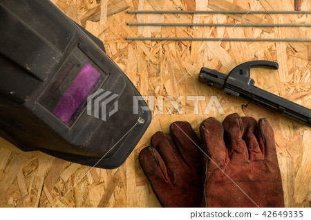 set of  welder tools on wood background 42649335