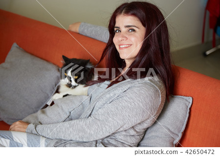 Woman resting at home with cat 42650472