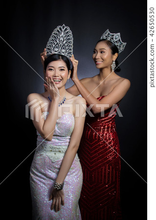 Last year winner Miss Beauty Pageant Contest put Diamond Crown on Final Winner latest year Miss Beauty Queen Pageant Contest with feeling wow smile glad face expression, two asian women moment sessio 42650530