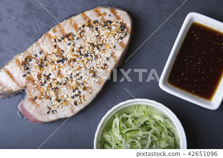 Grilled tuna with sesame and cucumber salad 42651096