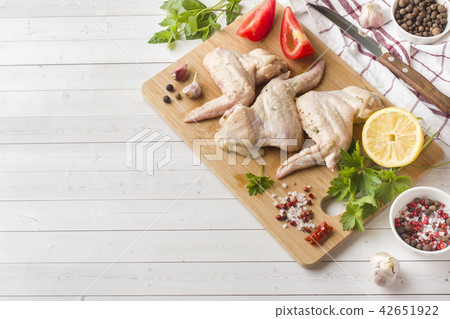 Raw chicken wings in marinade with sauce, pepper  42651922
