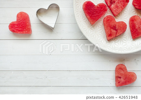 Hearts carved out of watermelon.  42651948