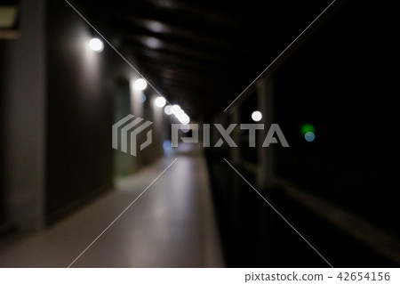 Walk in front of the room at night.  42654156