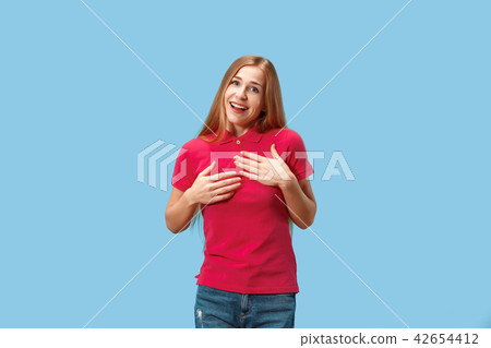 The happy business woman standing and smiling against blue background. 42654412