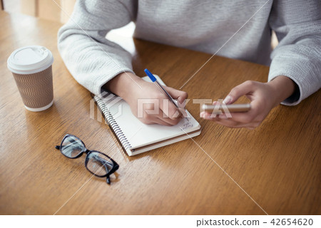 Young woman working at creative stylish office sitting holding s Young woman working at creative stylish office sitting holding s 42654620
