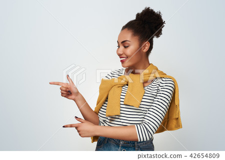 Young woman studio isolated in white pointing at wall aside Young woman studio isolated in white pointing at wall aside 42654809