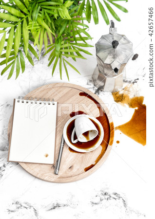 Office table note paper spilled coffee green plant 42657466