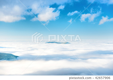 Mountain peak in the clouds Mountain peak in the clouds 42657906