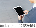businessman operating a tablet 42659469