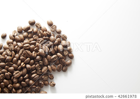 roasted coffee beans poured from clear glass roasted coffee beans poured from clear glass 42661978