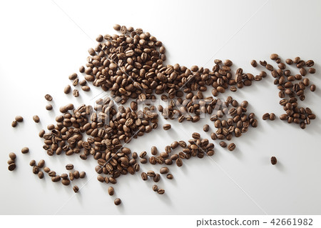 roasted coffee beans poured from clear glass 42661982