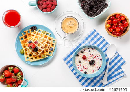 Photo of Viennese waffles, oatmeal, coffee, fresh berries Photo of Viennese waffles, oatmeal, coffee, fresh berries 42671705