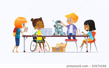 Disabled African American girl in wheelchair and other children standing around desk with laptops Disabled African American girl in wheelchair and other children standing around desk with laptops 42674266