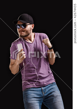 man listening to music in headphones man listening to music in headphones 42674435